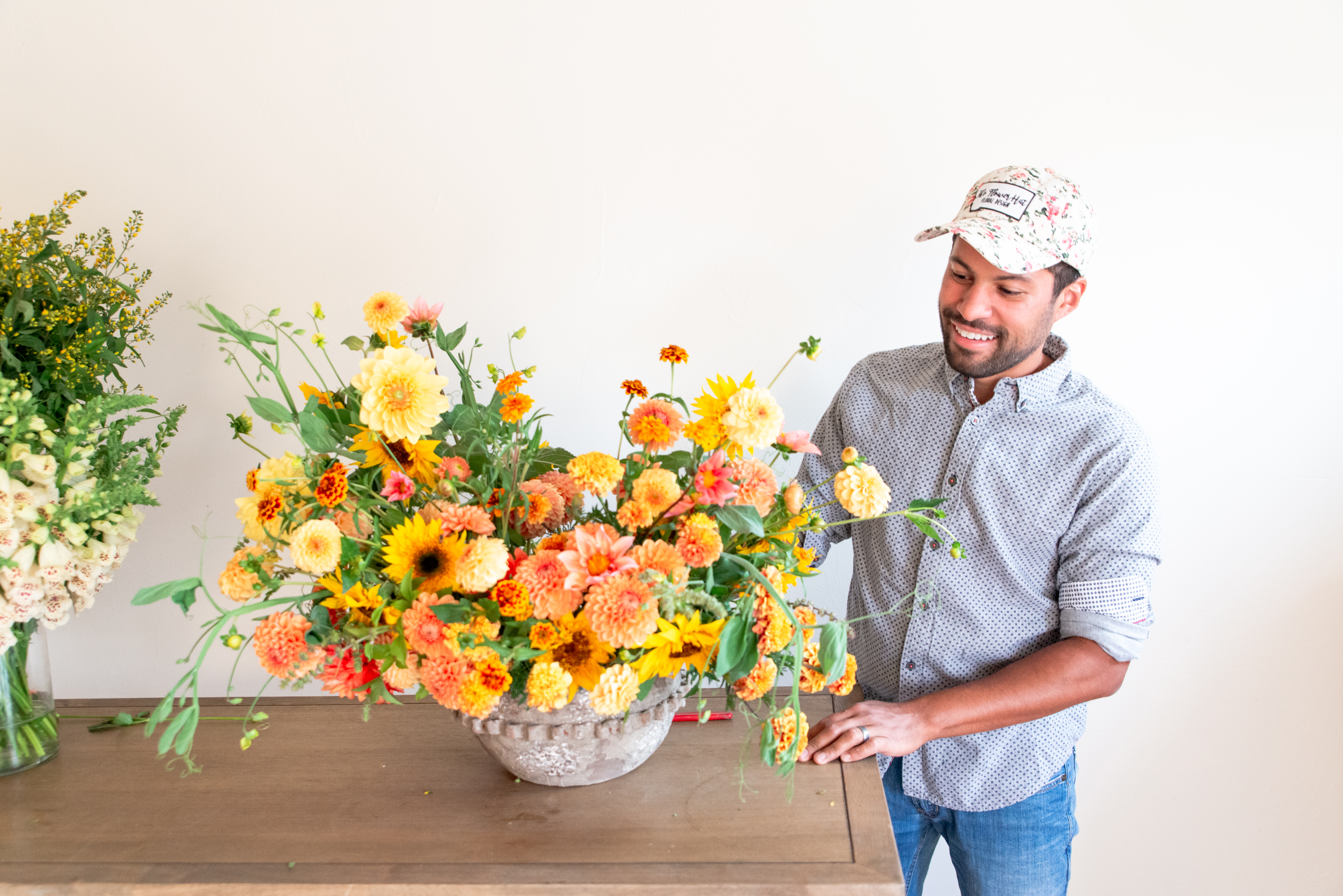 The Flower Hat designing a large floral arrangement
